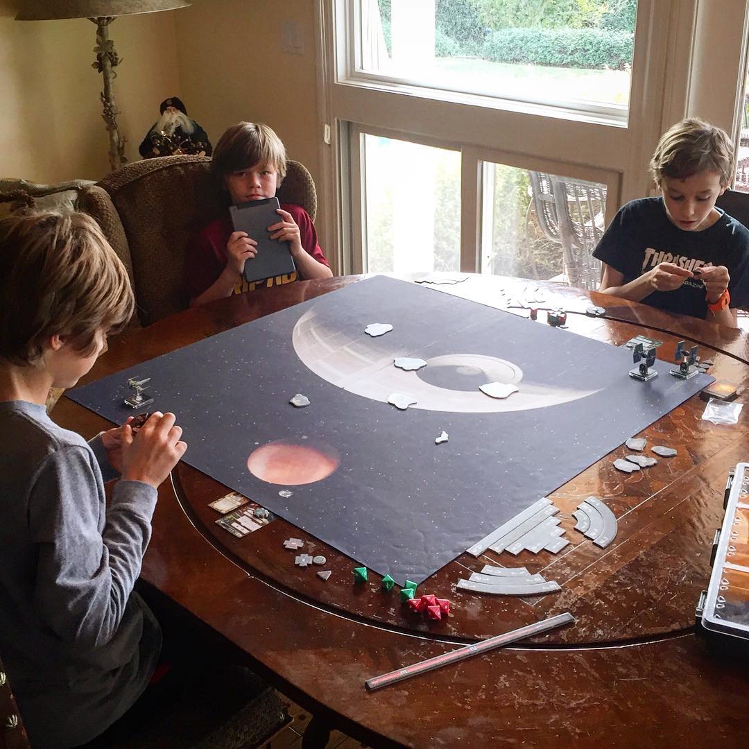 Giving a demo of X-Wing: The Miniatures Game to the cousins. I think we've got some new fans.